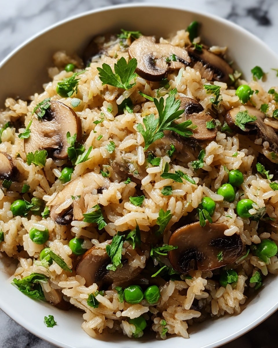 A close-up view of a white bowl filled with one layer of cooked rice mixed with sliced brown mushrooms and green peas throughout. The rice grains are soft and slightly shiny, showing a light brown color from cooking. Scattered fresh green parsley leaves sprinkle over the top and within, adding bright green color and texture. The bowl sits on a white marbled surface, and the image captures the dish’s warmth and freshness with a soft natural light. photo taken with an iphone --ar 4:5 --v 7