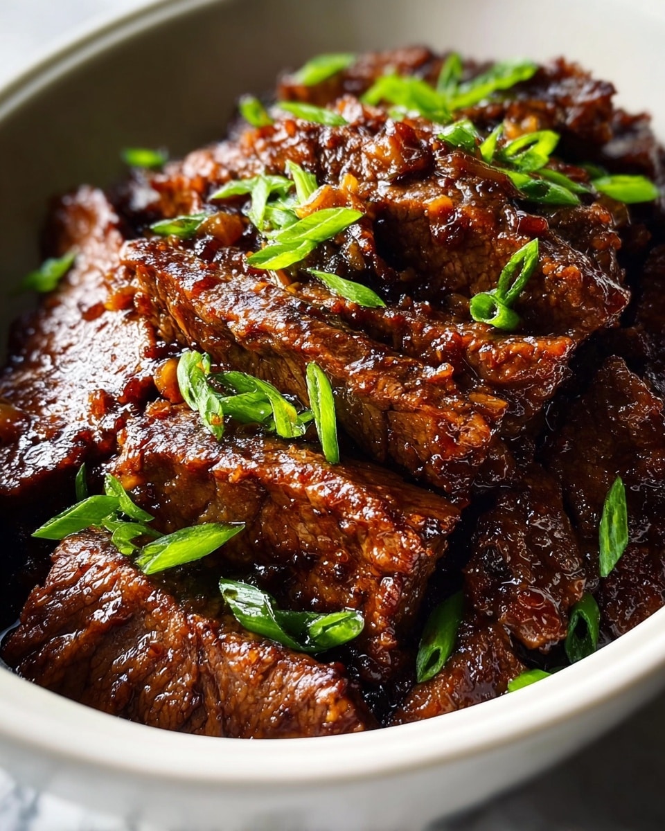 The image shows a close-up of cooked beef slices with a shiny, dark brown glaze in a white bowl, arranged in a layered pile covering the base. The meat has a tender texture with visible grill marks and is mixed with bright green chopped scallions scattered evenly over the top, adding a fresh contrast to the rich color of the beef. The bowl sits on a white marbled surface, highlighting the deep tones of the dish. photo taken with an iphone --ar 4:5 --v 7