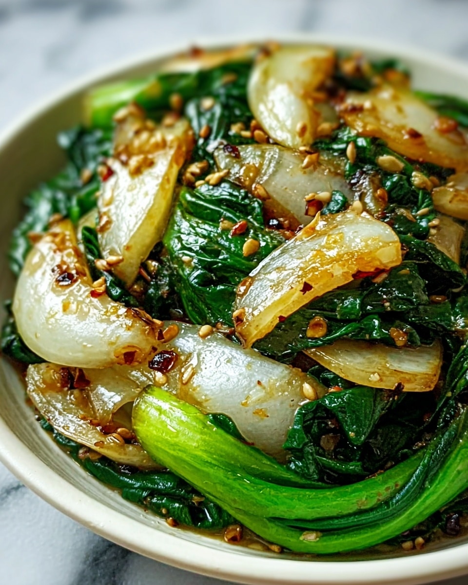 The image shows a close-up of a dish with about two layers. The base layer is made of bright green leafy vegetables that look fresh and slightly cooked, with smooth textures and visible veins. The top layer consists of thick, translucent white and slightly browning pieces of cooked vegetable, possibly onions or bok choy stems, mixed with small toasted sesame seeds sprinkled evenly on top. The food sits in a shallow white bowl, placed on a white marbled surface. Photo taken with an iphone --ar 4:5 --v 7