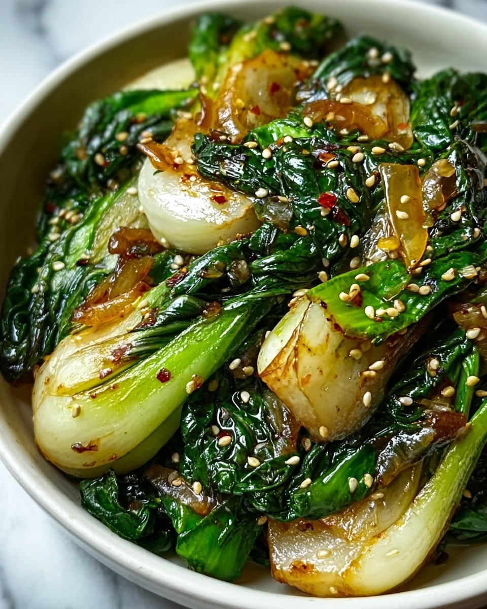 This close-up shows a bowl full of cooked bok choy with thick, juicy stems that are pale green and white, mixed with dark green crinkly leaves. The stems look shiny and soft, with some parts caramelized to a light brown. The green leaves are wilted but still vibrant, curling around the stems. Light brown sesame seeds are sprinkled over the dish, adding small pops of texture and a speckled look. The white bowl sits on a white marbled surface, highlighting the fresh colors of the vegetables. photo taken with an iphone --ar 4:5 --v 7