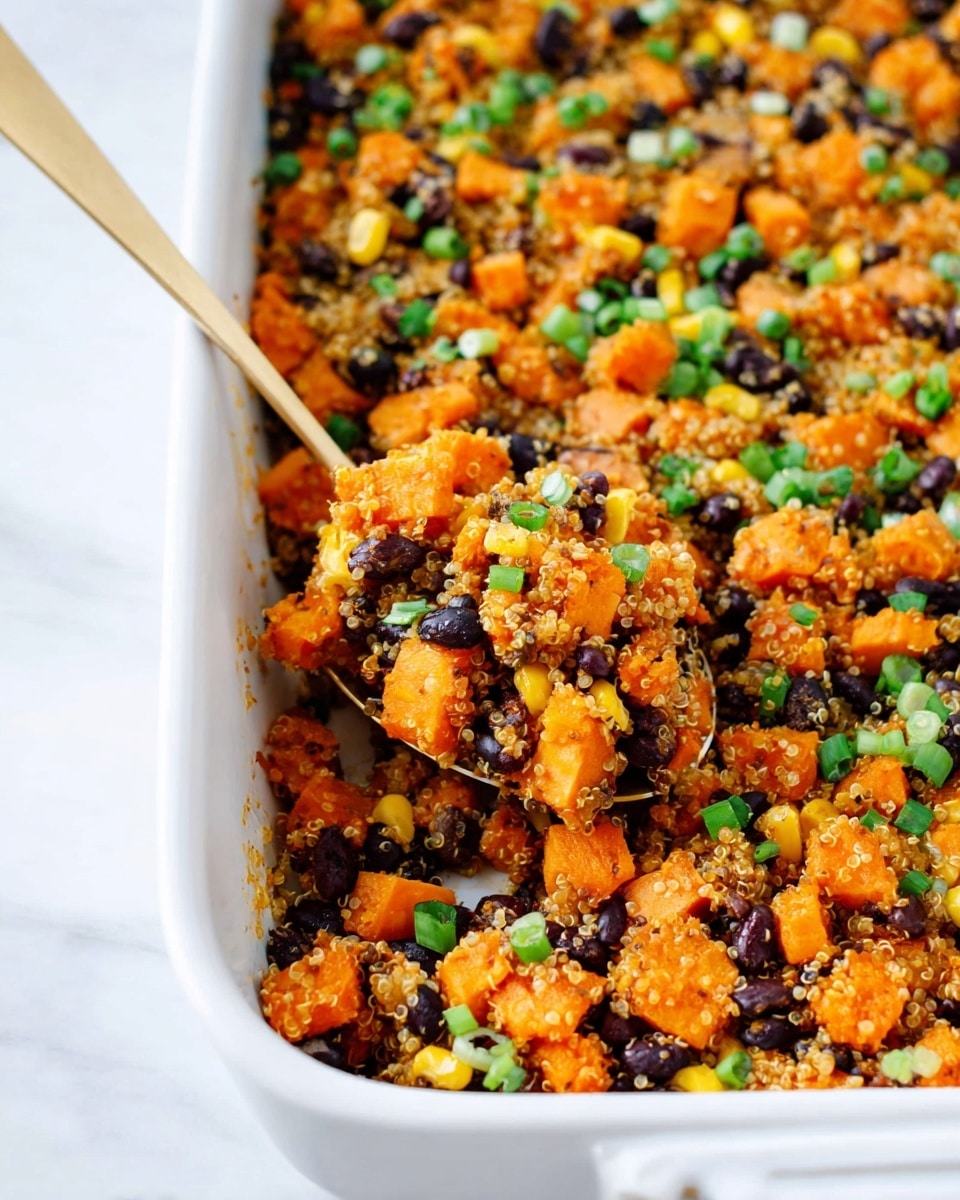 A close-up view of a white rectangular baking dish filled with a colorful mixed dish. The dish has an even layer of small cubed orange sweet potatoes, black beans, light yellow corn kernels, and cooked quinoa grains spread throughout. On top, there are scattered pieces of chopped green onions adding a fresh green color. A gold spoon is partially inside the dish, lifting a portion, showing the mixture's texture and layers more clearly. The baking dish sits on a white marbled textured surface photo taken with an iphone --ar 4:5 --v 7