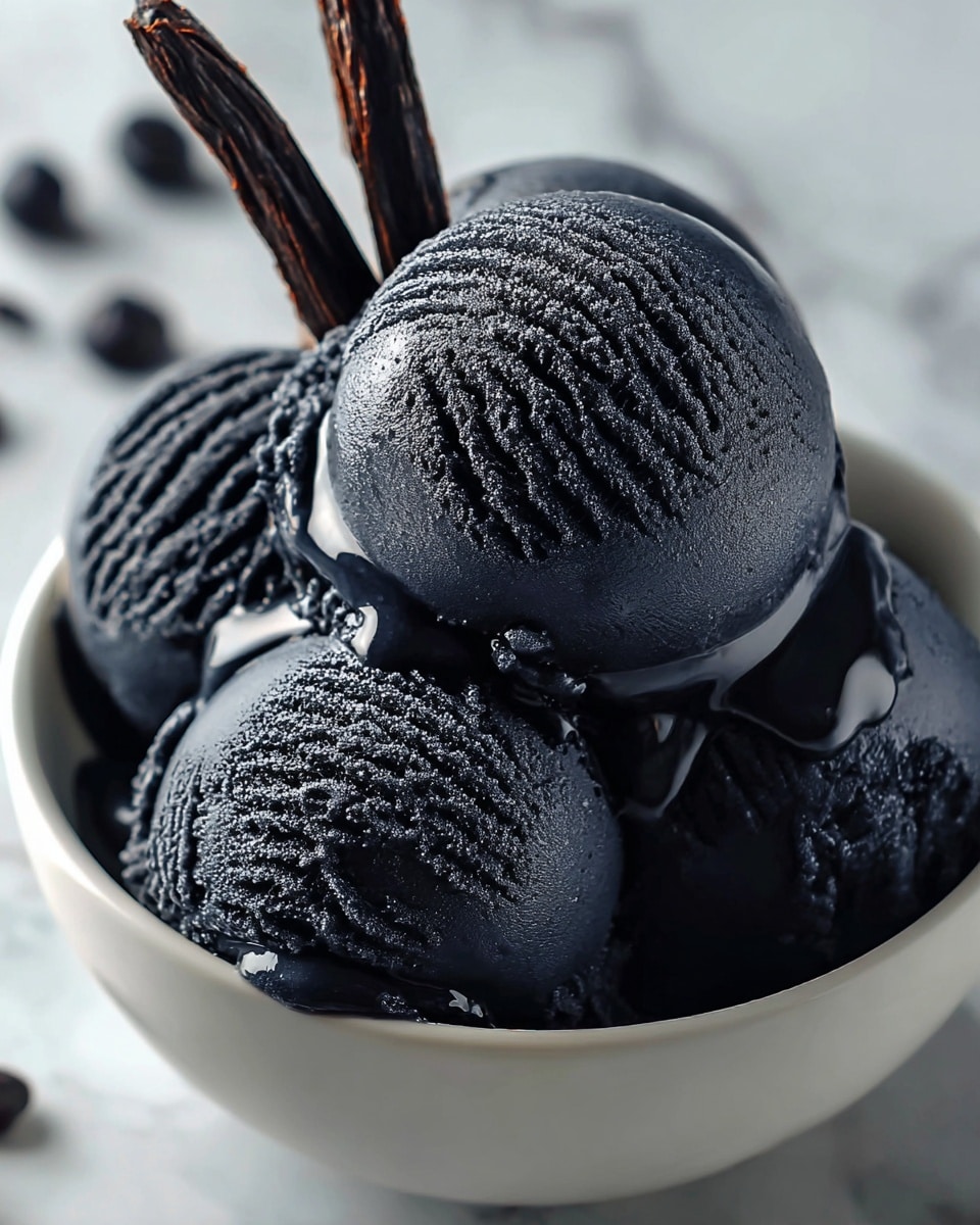 A white bowl filled with several scoops of deep black ice cream stacked on top of each other. The smooth ice cream has a textured, slightly frosty surface with visible ridges and glossy areas where it reflects light. Thin, dark sticks or wafers rise from the bowl’s center, adding height and contrast. The background shows a soft, white marbled texture, and the scene is brightly lit, emphasizing the rich black color and creamy texture of the ice cream. Photo taken with an iphone --ar 4:5 --v 7