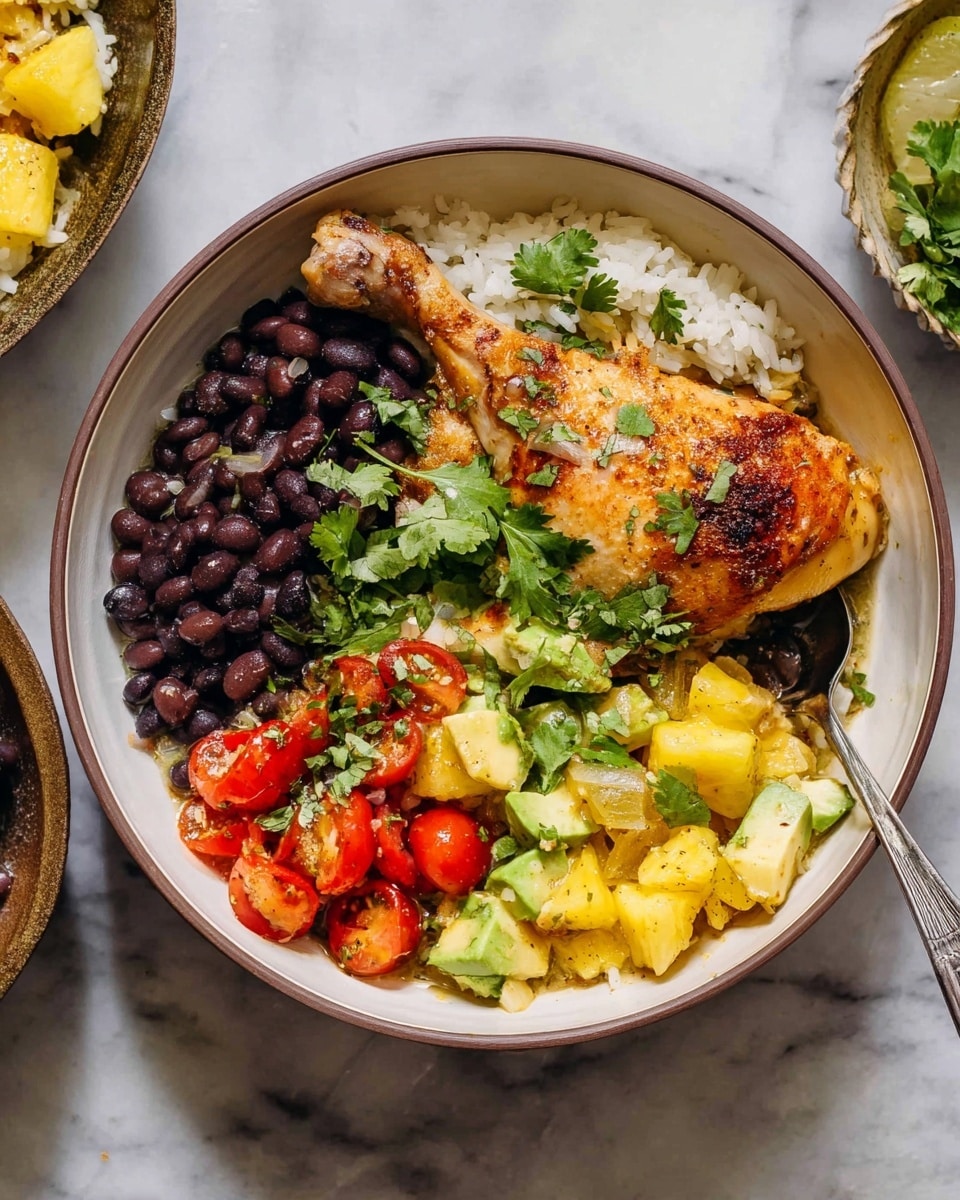 The image shows a white bowl filled with four main layers of food. At the bottom is a layer of white rice, topped with black beans on one side and bright red cherry tomato halves scattered among the beans. Next to the beans is a golden-brown roasted chicken leg, garnished with fresh green cilantro leaves on top. Around the chicken, there are large pieces of cooked, slightly browned onions and small yellow pineapple chunks mixed with green avocado cubes. The bowl sits on a white marbled surface, with a silver spoon resting inside. photo taken with an iphone --ar 4:5 --v 7
