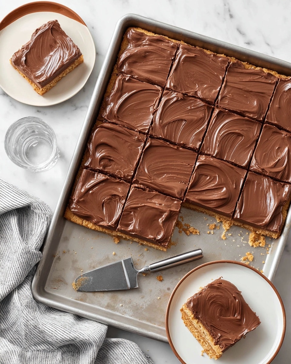A metal baking tray holds a large square dessert cut into 12 equal squares; the bottom layer is a light golden, crumbly cookie crust with a rough texture, topped with a thick, smooth chocolate frosting layer that is glossy and spread evenly with wave-like swirls. Three pieces are removed from the tray, with one piece resting on a white plate with a brown rim at the top left corner, and another white plate with a brown rim sits empty to the right. A clear glass of water is placed near the top center. A silver spatula with a black handle lies inside the tray beside the removed pieces. The surface beneath everything is a white marbled texture, and a gray and white striped cloth is at the bottom left corner. photo taken with an iphone --ar 4:5 --v 7