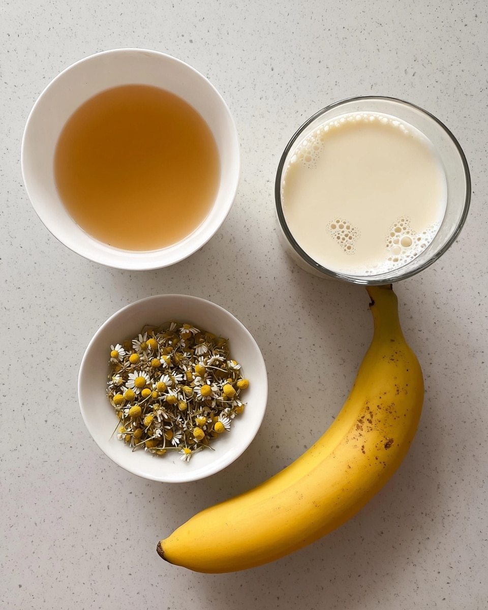 The image shows four items arranged neatly on a white marbled surface. At the top left, there is a white bowl filled with a light amber liquid, smooth and clear. To its right, a clear glass cup contains creamy milk with foam bubbles on the surface, slightly off-white in color. Below the bowl, there is another white bowl holding dry chamomile flowers, small with yellow centers and delicate white petals. On the right side, there is a ripe banana with a yellow peel marked by a few dark spots, showing some natural texture. Photo taken with an iphone --ar 4:5 --v 7