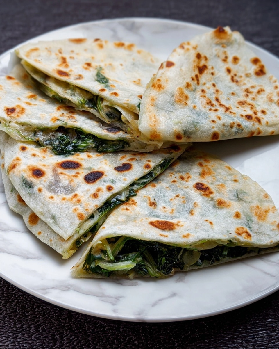 The image shows three flatbread wraps folded in halves and quarters placed on a white plate, each piece having a thin outer layer that is light beige with brown spots and slightly charred areas. Inside, there is a visible layer of cooked green leafy vegetables that look soft and slightly wilted, giving a mix of dark and light green textures. The flatbreads are slightly translucent in some areas, showing hints of the green filling inside. The plate is on a white marbled surface. photo taken with an iphone --ar 4:5 --v 7